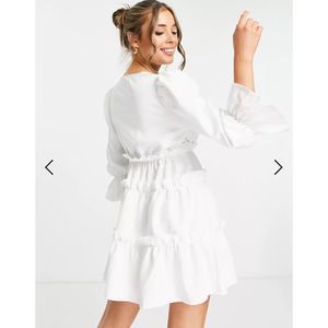 In The Style x Billie Faiers wrap over flutter sleeve tiered mini dress in white